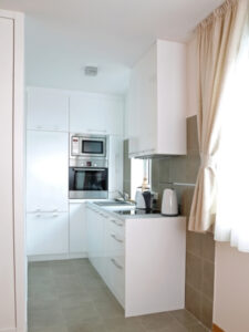 White kitchen with tower ovens