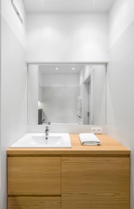 Small and functional bathrooms with light wood furniture